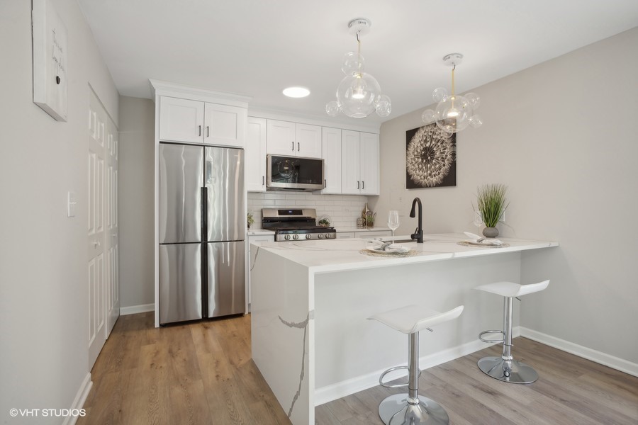 16 Forest Lane Cary, IL 60013 - Photo 5 of 18 a kitchen with stainless steel appliances a refrigerator and a stove top oven