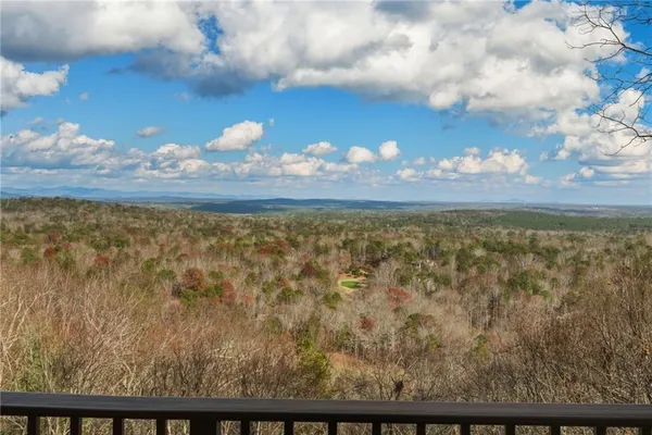 a living room with furniture a flat screen tv and a floor to ceiling window