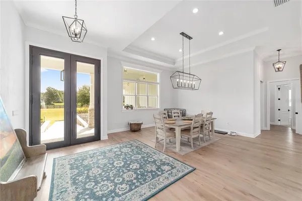 a kitchen with white cabinets and appliances