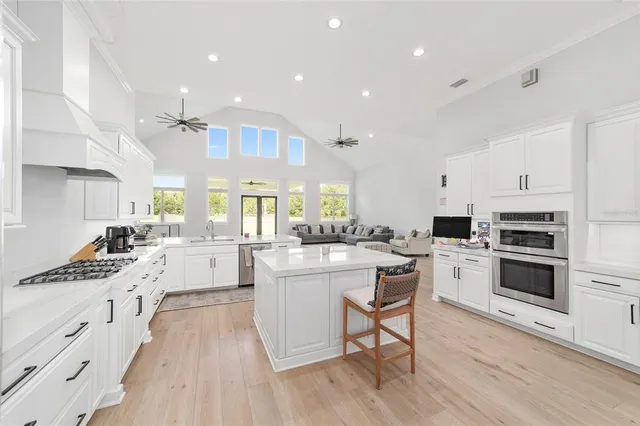 a kitchen with counter top space sink stove and cabinets