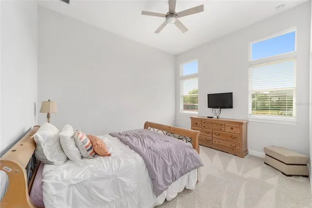a bedroom with a bed couch and a window