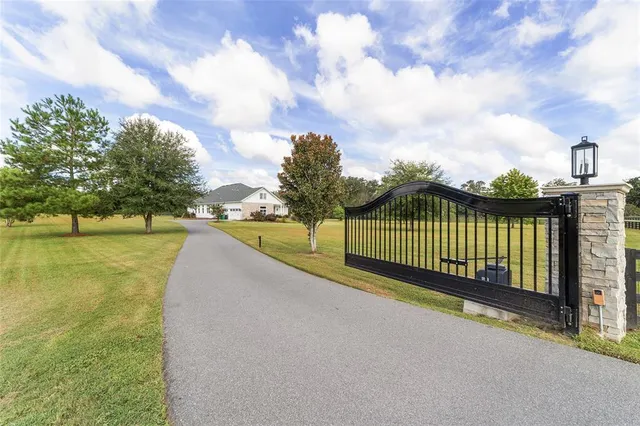 a view of a pathway with a wrought fence