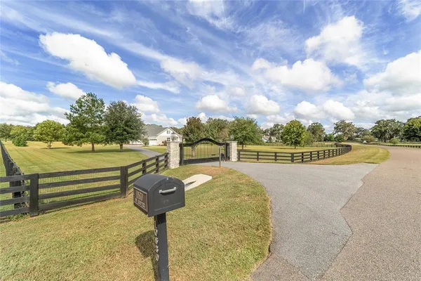 a view of swimming pool with outdoor seating and yard in back