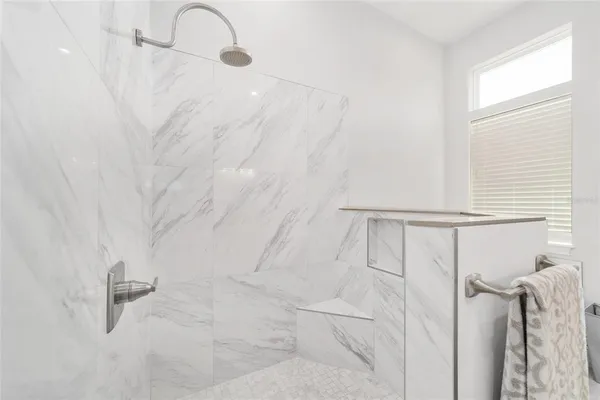a bathroom with a granite countertop sink a toilet and shower