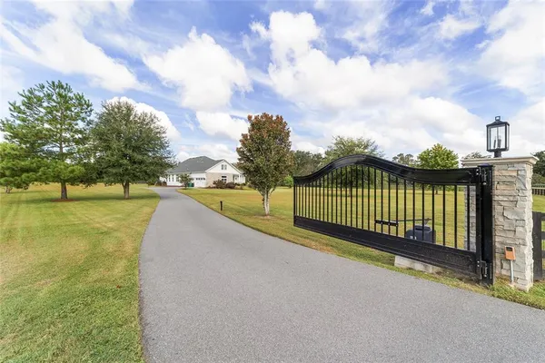 a view of a pathway with a wrought fence