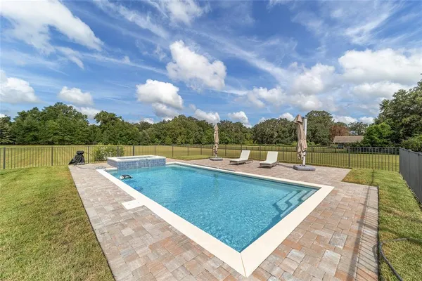 a view of a swimming pool with a lounge chairs