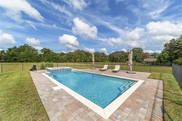 a view of a swimming pool with a lounge chairs