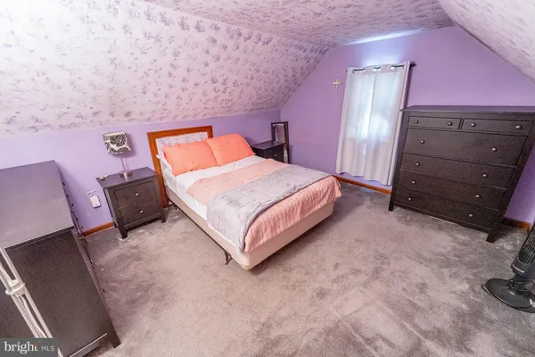 a bedroom with a bed and dresser