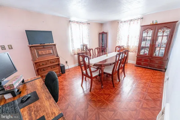 a dining room with furniture and wooden floor