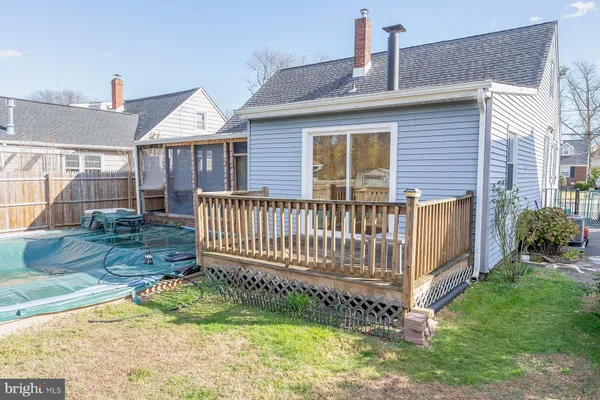 a view of a house with a yard and deck