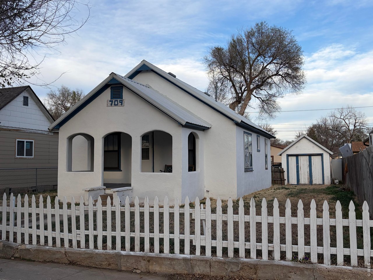 709 South 3rd Street Lamar, CO 81052 - Photo 1 of 20 a front view of a house with a garden