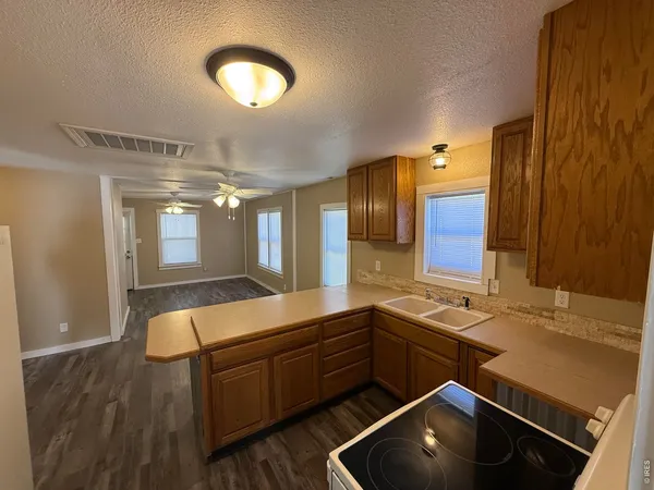 a room with stainless steel appliances lots of counter space and cabinets
