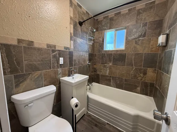a bathroom with a toilet and shower
