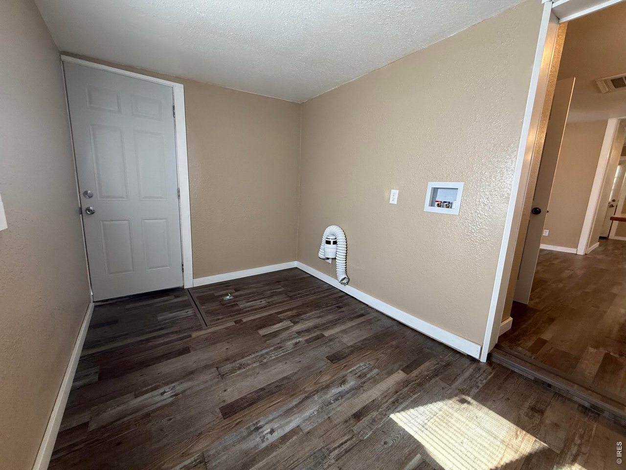 709 South 3rd Street Lamar, CO 81052 - Photo 15 of 20 a view of an empty room with wooden floor and a window
