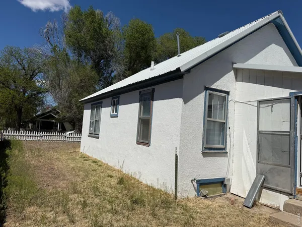 a backyard of a house with table and chairs