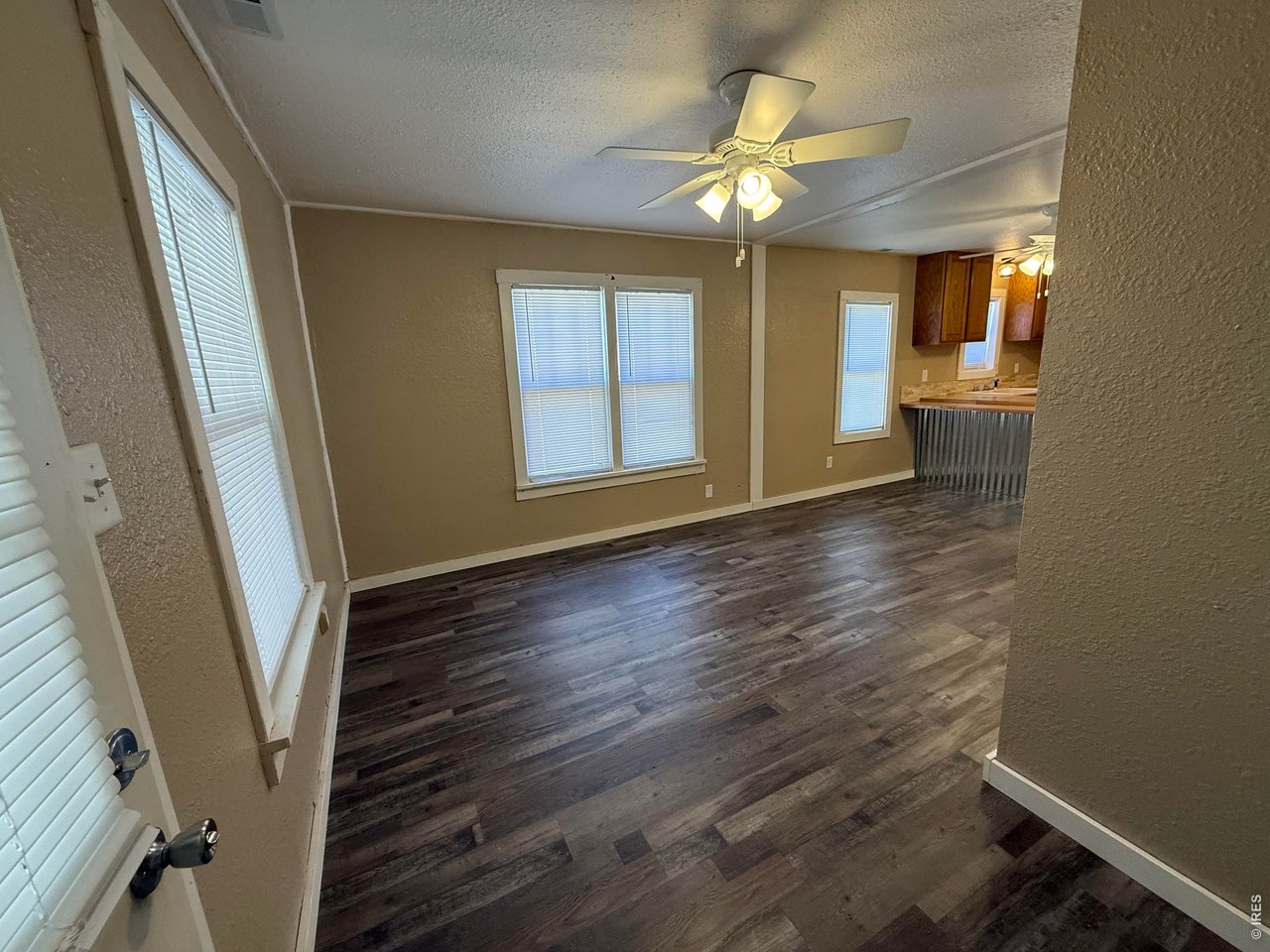 709 South 3rd Street Lamar, CO 81052 - Photo 3 of 20 wooden floor in an empty room with a window