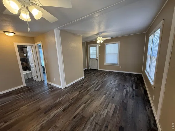 wooden floor in an empty room with a window