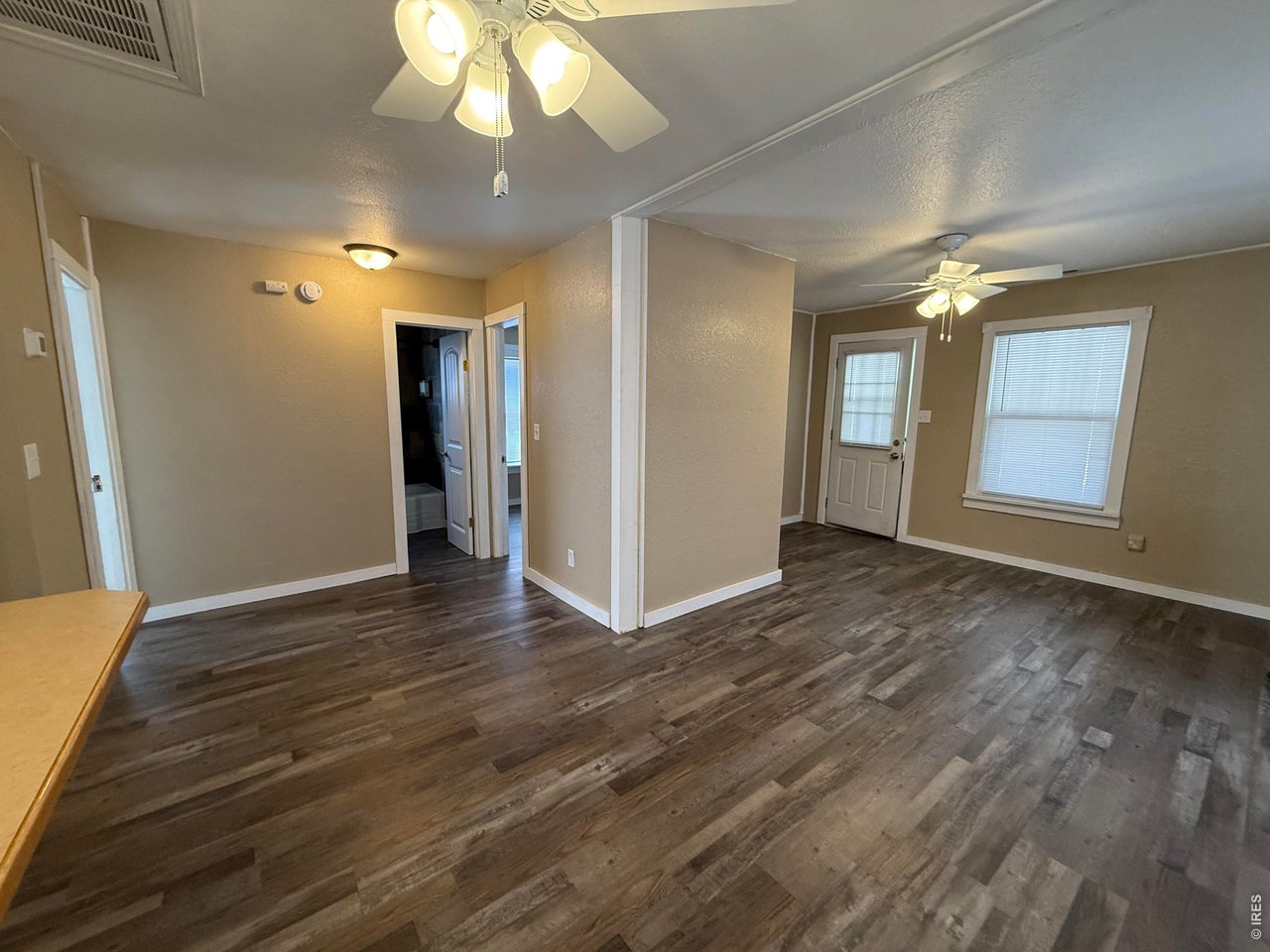 709 South 3rd Street Lamar, CO 81052 - Photo 8 of 20 a view of an empty room with window and wooden floor