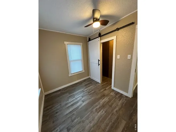 a view of hallway with wooden floor
