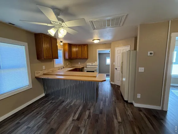 a view of kitchen with sink microwave and refrigerator