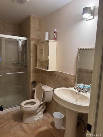 23 Notingham Circle, Unit 23 Peekskill, NY 10566 - Photo 10 of 12 Bathroom with tile walls, a shower stall, light tile patterned floors, and a wainscoted wall