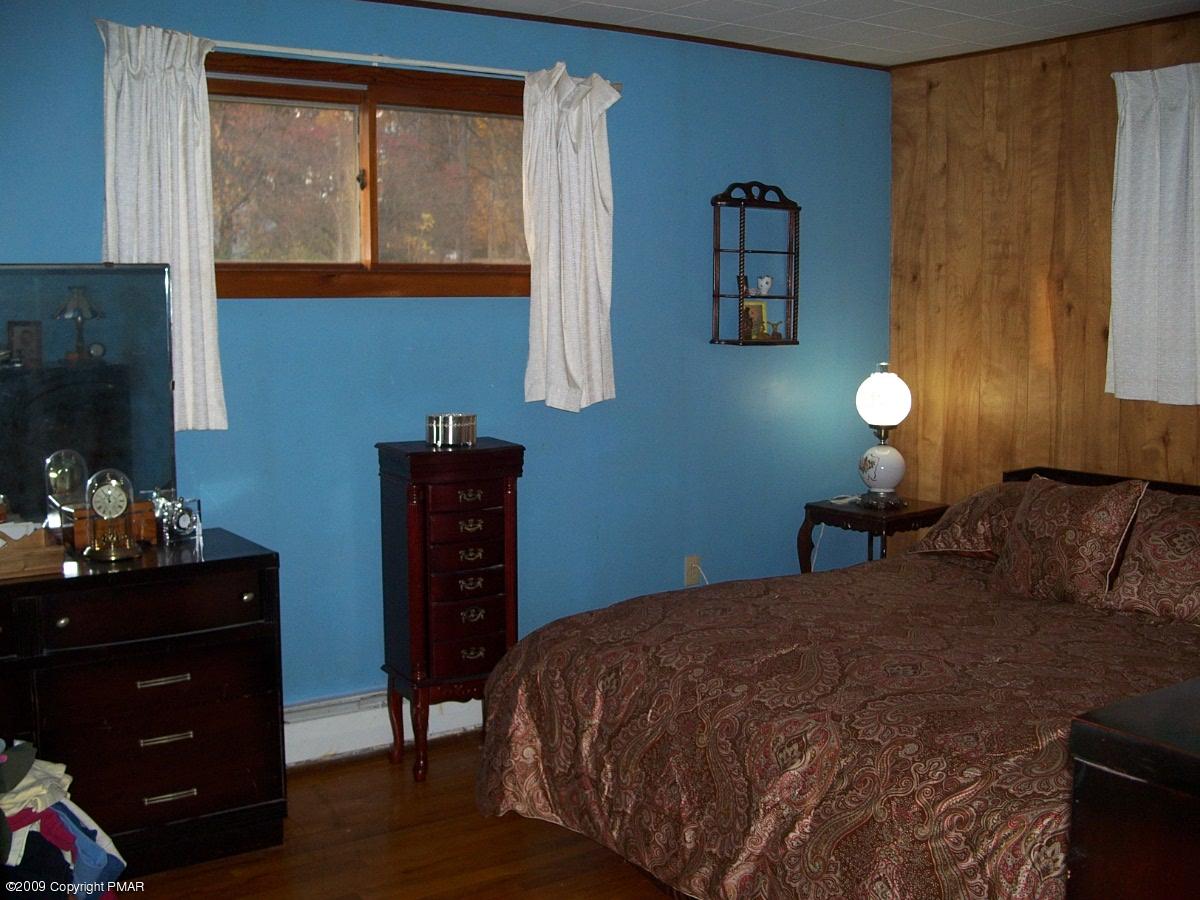 137 Independence Road East Stroudsburg, PA 18301 - Photo 14 of 15 a bedroom with a bed and wooden floor