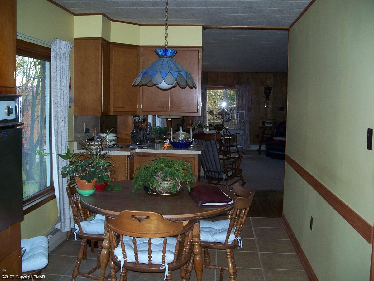 137 Independence Road East Stroudsburg, PA 18301 - Photo 9 of 15 a dining room with furniture a kitchen a chandelier and wooden floor