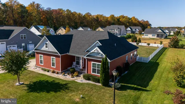 a aerial view of a house next to a yard