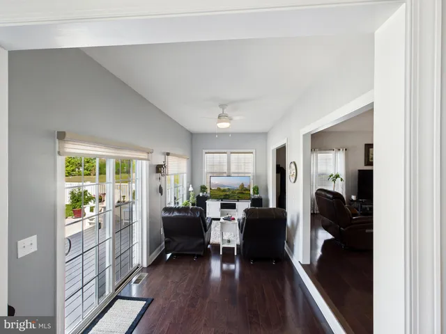 a view of a livingroom with furniture hardwood floor and a large window