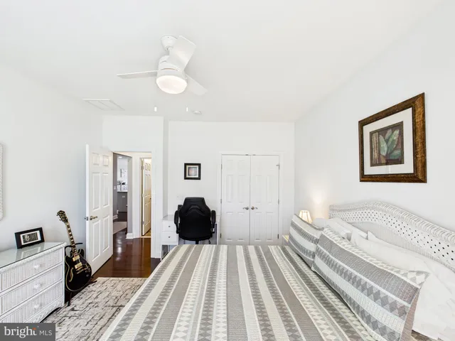 a spacious bedroom with a bed and a chandelier