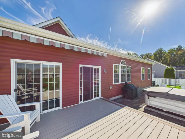 a front view of house with deck and seating space