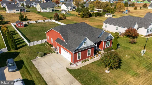 an aerial view of a house with a yard basket ball court and outdoor seating