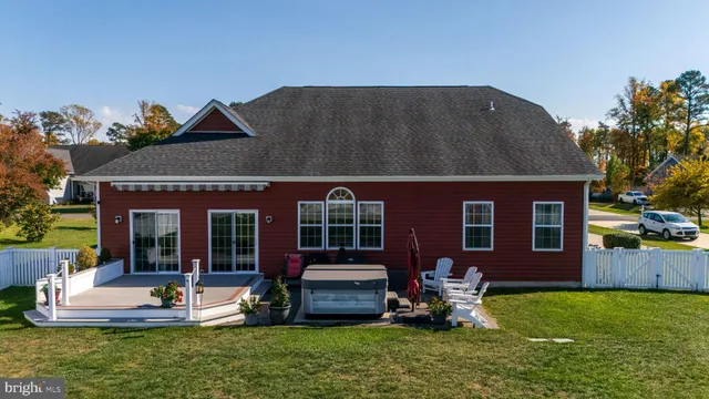 a backyard of a house with table and chairs
