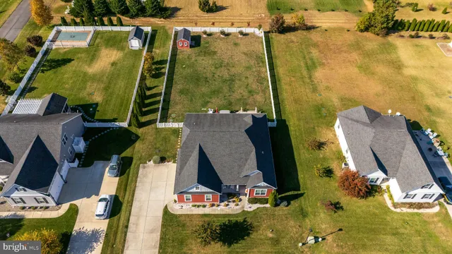 an aerial view of residential house with outdoor space and parking