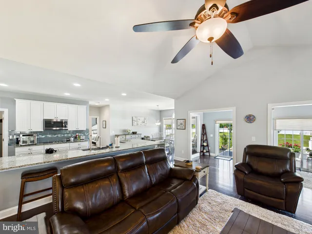 a living room with stainless steel appliances kitchen island granite countertop furniture and a kitchen view