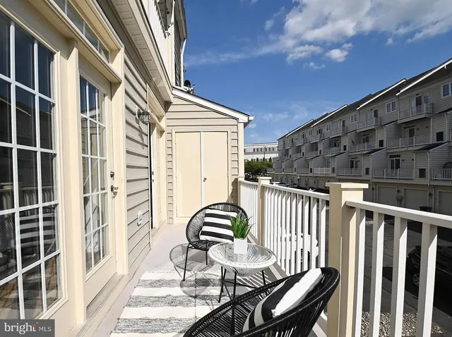 a view of balcony with wooden floor and outdoor seating