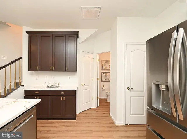 a kitchen with stainless steel appliances granite countertop a refrigerator and a sink