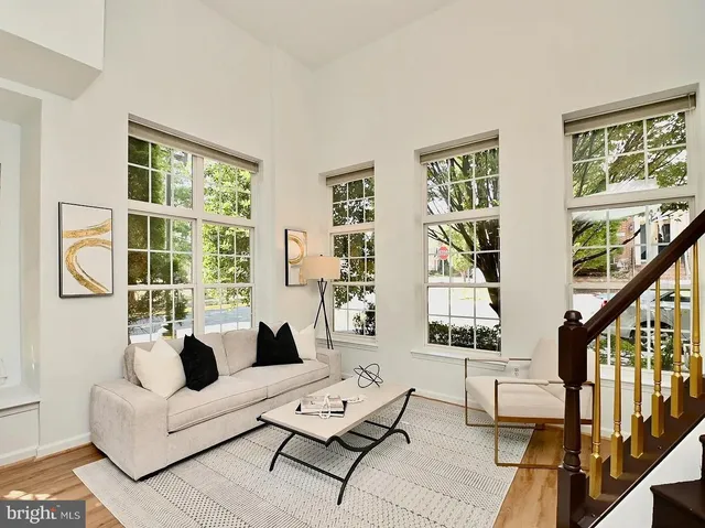 a living room with furniture and large windows