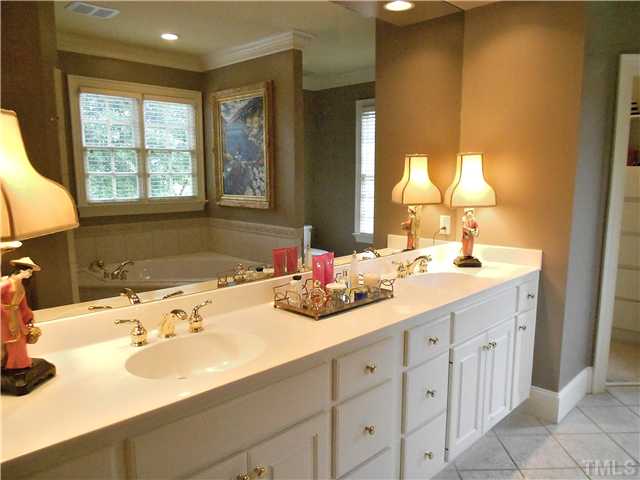 323 Marlowe Road Raleigh, NC 27609 - Photo 13 of 25 a bathroom with a sink and a mirror