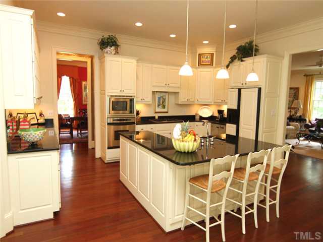 323 Marlowe Road Raleigh, NC 27609 - Photo 6 of 25 a kitchen with stainless steel appliances kitchen island granite countertop a stove and cabinets