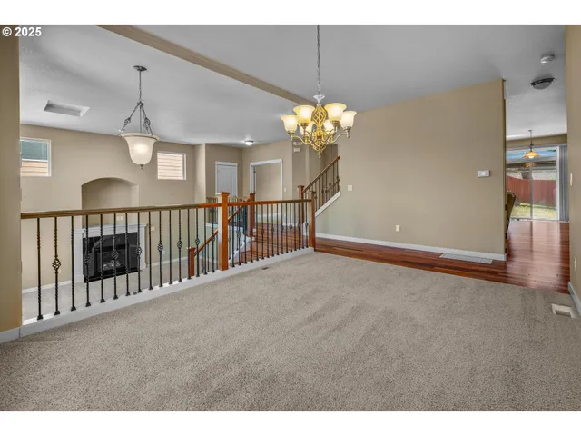 a view of a livingroom with a furniture chandelier entryway and wooden floor