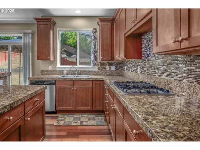 a kitchen with a stove a sink and a microwave