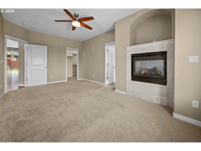 a view of a livingroom with a ceiling fan and window