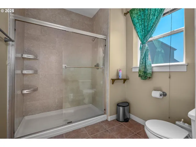 a bathroom with a shower and a toilet