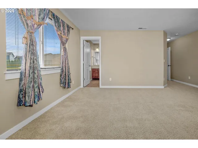 a view of an empty room with closet