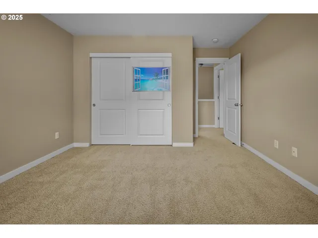 a view of an empty room and wooden floor