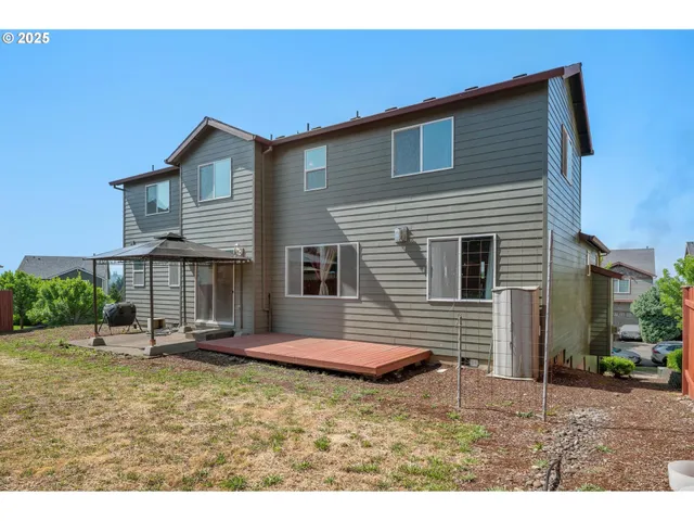 a backyard of a house with yard and outdoor seating