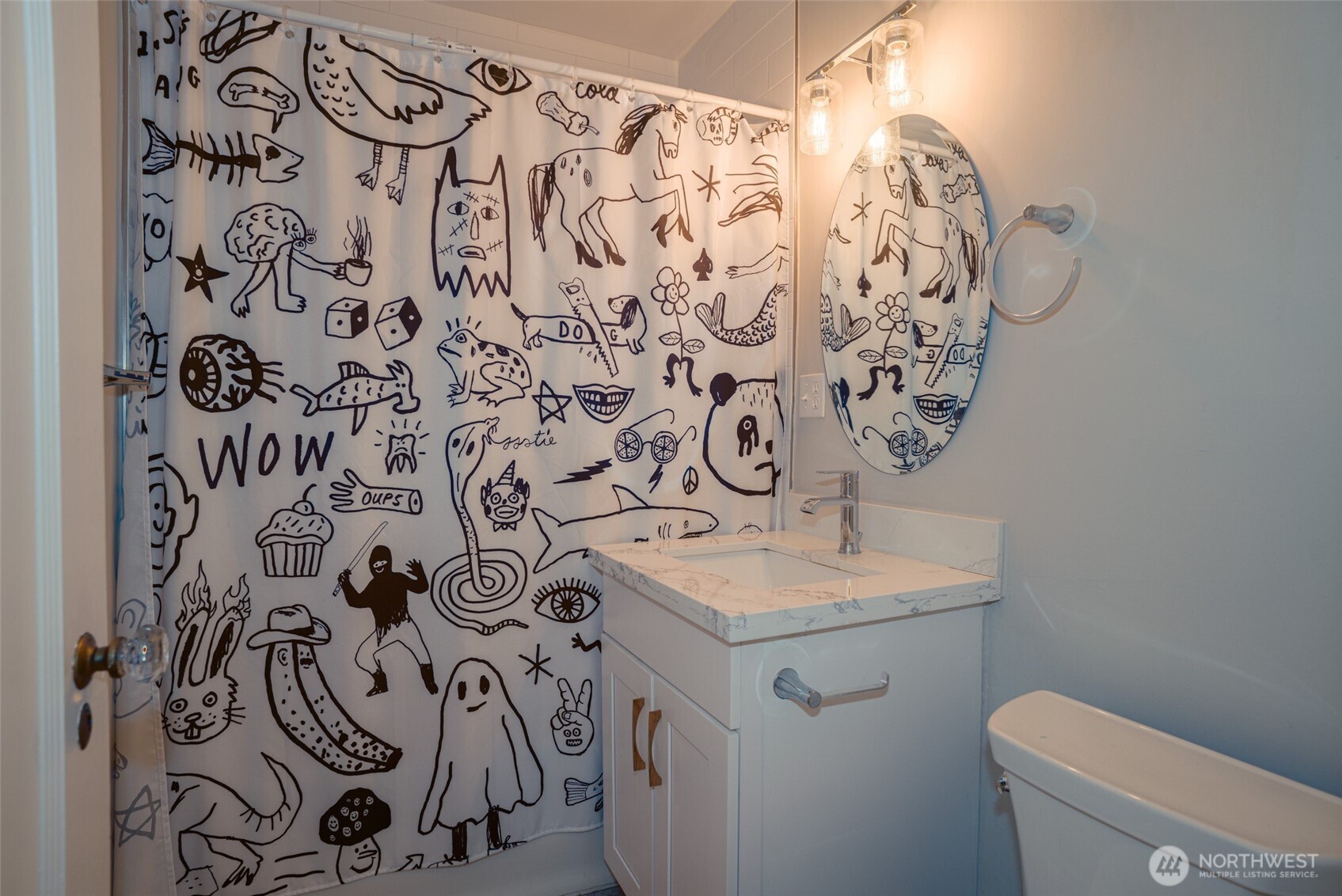 1605 East Olive Street, Unit 307 Seattle, WA 98122 - Photo 11 of 21 a bathroom with a sink and mirror with toilet