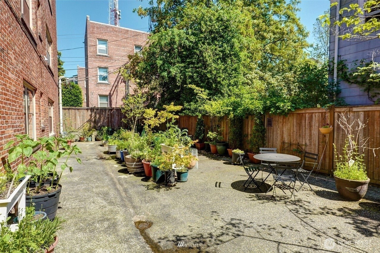 1605 East Olive Street, Unit 307 Seattle, WA 98122 - Photo 16 of 21 a view of a chairs and table in a backyard