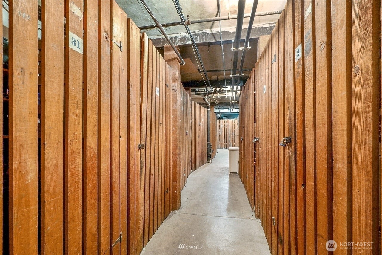 1605 East Olive Street, Unit 307 Seattle, WA 98122 - Photo 17 of 21 a hallway with wooden floor windows and furniture
